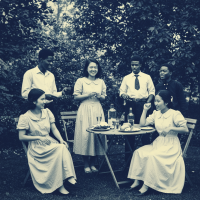 A vintage black-and-white photo of six people in formal attire gathered outdoors around a table, capturing a moment that could cement or poison their friendship.