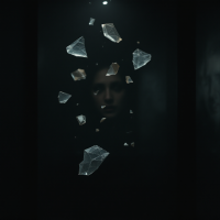 A shadowy figure partially obscured by shattered glass fragments, illustrating the haunting duality of memories as both comforting and terrifying.