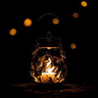 A beautifully crafted lantern with a warm glow stands against a dark background, symbolizing hope and guidance in darkness, reflecting the essence of finding light amidst shadows.