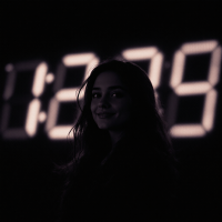 A woman smiles softly against a dark background, illuminated by a large digital clock displaying 12:29, evoking a sense of anticipation from the quote, I’ve been waiting for you for a long time.